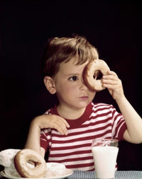 Close-Up of a Boy Looking Through a Donut Fine Art Print