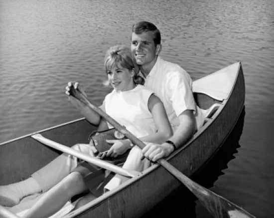 Young Couple Rowing a Rowboat - Fine Art Print