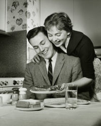 Young Woman Serving Steak to a Young Man Fine Art Print