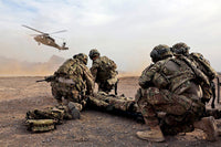 Security Force Team Members Awaiting UH-60 Blackhawk MedEvac Print by Stocktrek Images