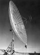 Engineer Standing on Ladder in Front of Parabolic Antenna Poster Print