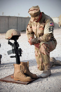 A Soldier Pays Tribute to a Fallen Comrade Fine Art Print by Stocktrek Images
