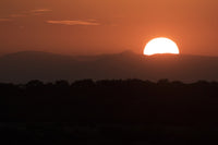 Setting Sun Over African Landscape Fine Art Print by Robert Postma