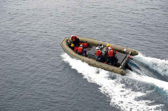 Sailors in a Rigid-Hull Inflatable Boat Conducting Operations Poster Print by Stocktrek Images