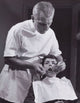 Male Dentist Examining a Boy's Teeth Fine Art Print