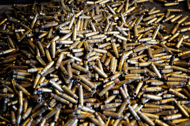 Empty 762mm Brass Casings Fine Art Print by Andrew Chittock