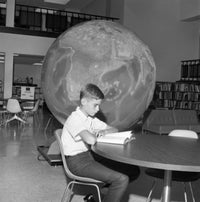 Boy Reading Book in Library Fine Art Print