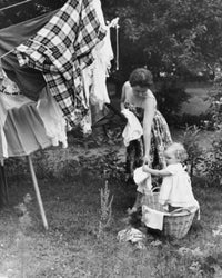Daughter Helping Her Mother Hang Clothes on a Clothesline Fine Art Print