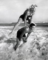 Young Couple Playing Leapfrog in Surf Fine Art Print
