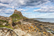 Rocky Outcrop Leading to Holy Island Castle Art Print by Carol McKay