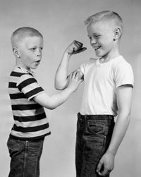 Boy Touching His Brother's Biceps Fine Art Print