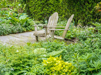Adirondack Chairs on a Garden Patio Fine Art Print by Julie Eggers