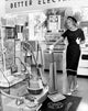 Young Woman Holding a Vacuum Cleaner in a Store Poster Print