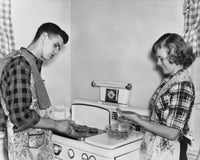 Teenage Couple Cooking Hamburgers on a Stove Fine Art Print