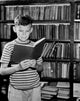 Boy Reading a Book in a Library Fine Art Print