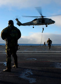 EOD Members Fast Rope Training with SH-60F Seahawk Poster Print by Stocktrek Images