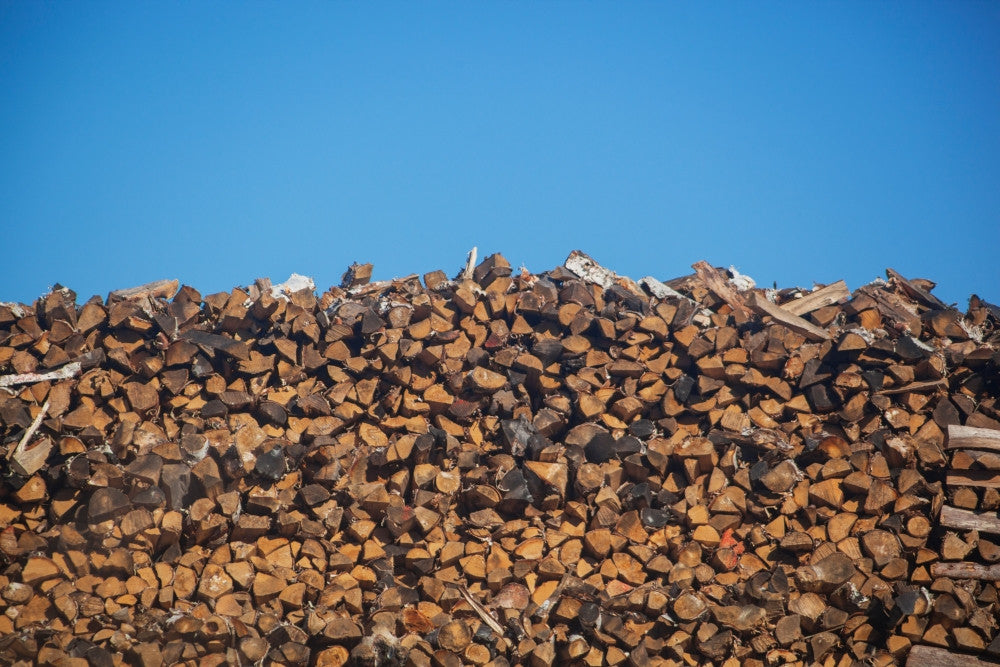 Stack of Firewood Pile Against Blue Sky Fine Art Print