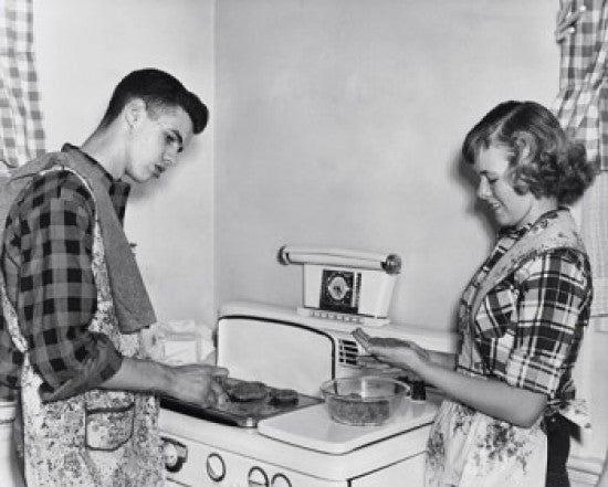 Teenage Couple Cooking Hamburgers on a Stove Fine Art Print