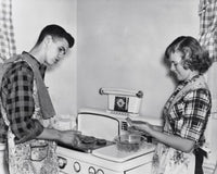 Teenage Couple Cooking Hamburgers on a Stove Fine Art Print