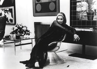 Classic photo print of Catherine Deneuve seated, showcasing her elegance.