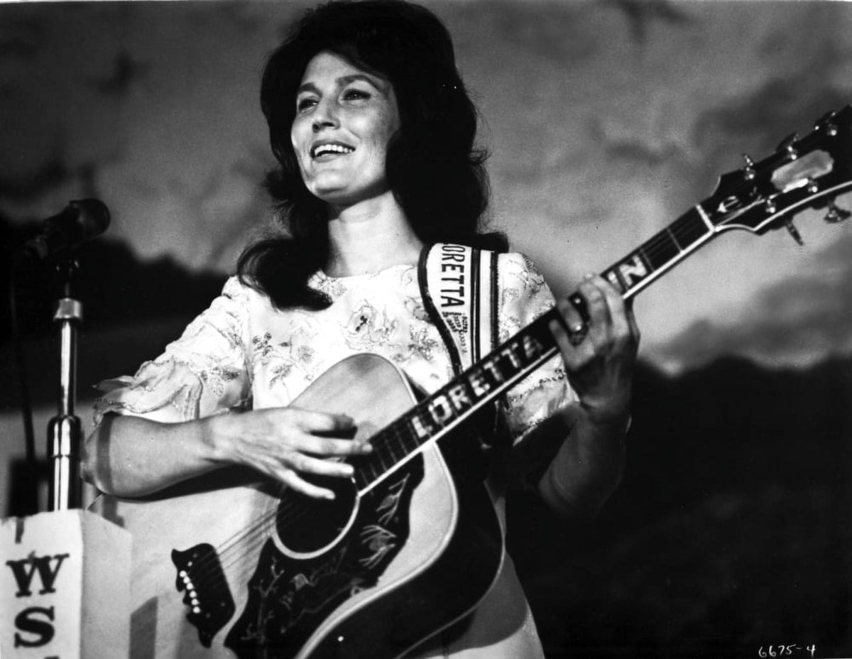 Classic photo print of Loretta Lynn playing guitar