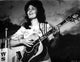 Classic photo print of Loretta Lynn playing guitar