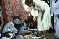 A man blessing Princess Diana's hand photo print.