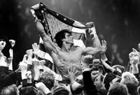 Sylvester Stallone carried by men holding a flag photo print.