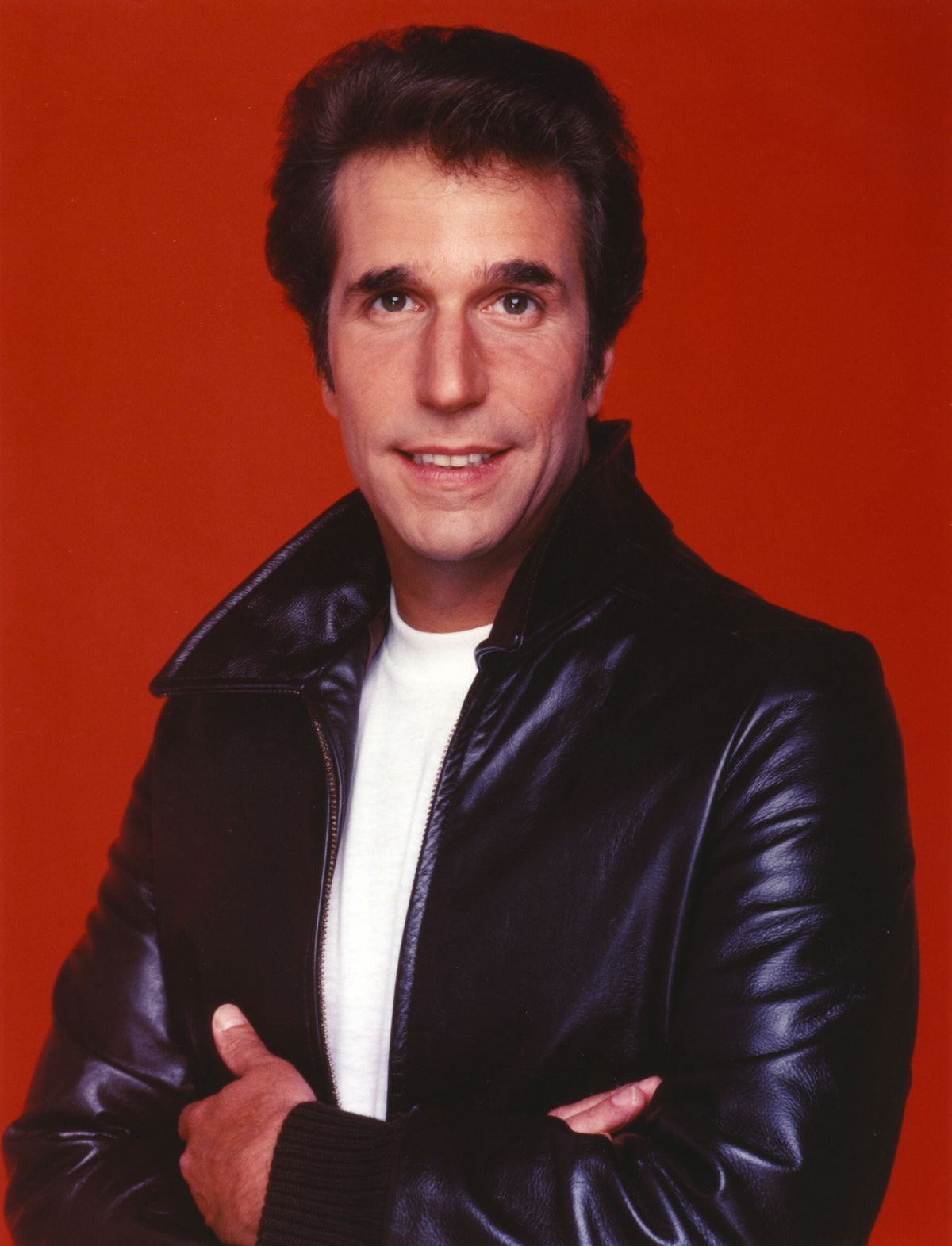 Henry Winkler photo print in a leather jacket on a red background.