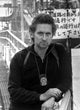 Michael Douglas with police badge photo print, available in multiple sizes.