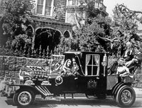 The Munsters family looking serious in a vintage car photo print.