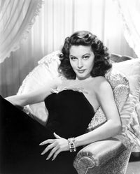 Ava Gardner photo print in black gown lying on a couch.