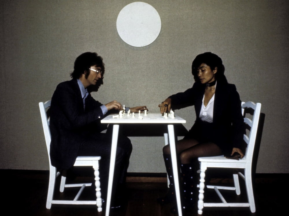 John Lennon playing chess with Yoko Ono photo print, iconic music art.
