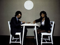 John Lennon playing chess with Yoko Ono photo print, iconic music art.