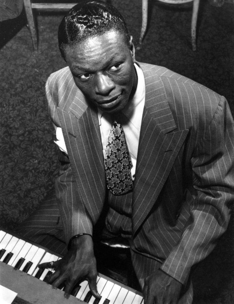 Nat King Cole performing photo print showcasing iconic jazz musician on stage.