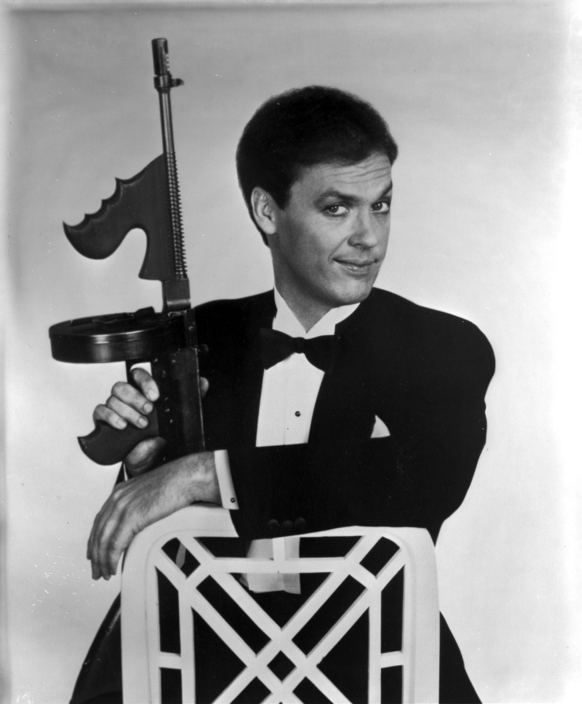 Michael Keaton holding a gun photo print, available in multiple sizes.