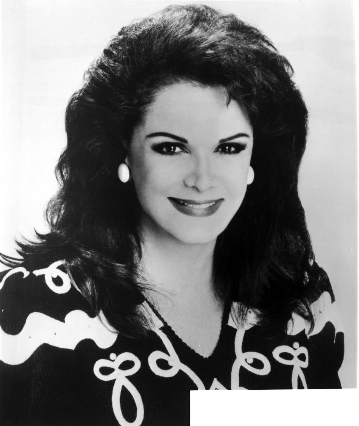 Connie Francis smiling in a black dress with pearl earrings photo print