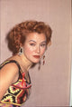 Jennifer Tilly leaning over in a multi-colored patterned dress at the 51st Golden Globes photo print.