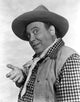 Joe Besser posed in checkered outfit and hat photo print