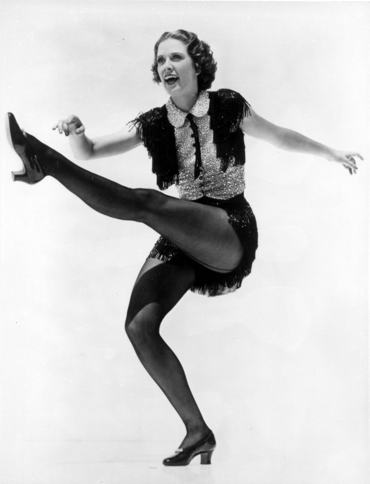 Eleanor Powell kicking photo print showcasing her dynamic dance pose.