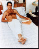 Mark Harmon shirtless photo print lounging on bed in white pants.