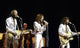 The Bee Gees live performance photo print capturing the iconic band on stage.