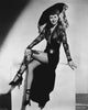 Classic portrait photo print of Barbara Stanwyck sitting with crossed legs