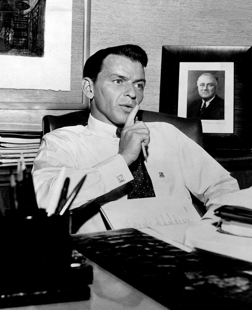 Frank Sinatra photo print at a desk, iconic music legend.