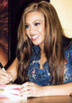 Beyonce signing autographs in denim top photo print.
