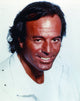 Close up portrait photo print of Julio Iglesias in a white formal outfit.