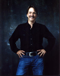 Jeff Foxworthy photo print in black top and jeans, hands on hips.