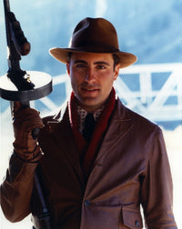 Andy Garcia holding a rifle photo print in multiple sizes.