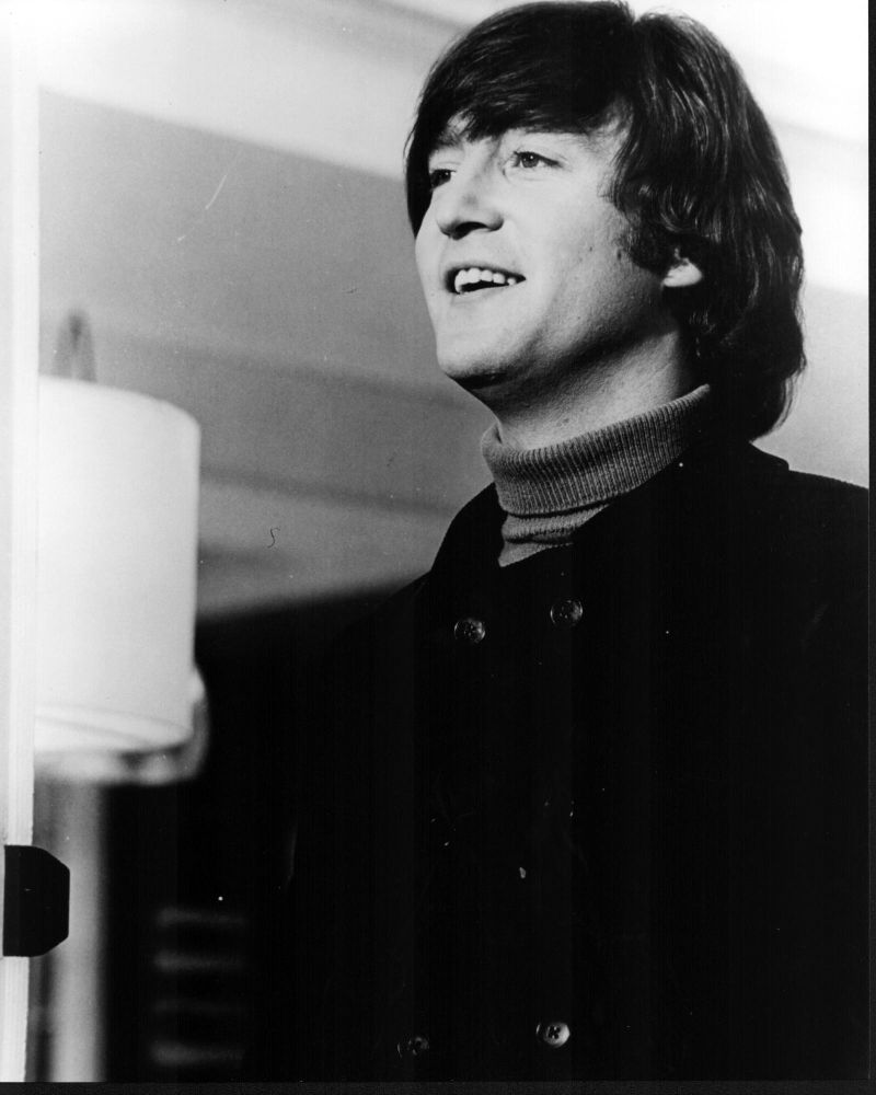 Black and white photo print of John Lennon in a turtleneck and jacket.