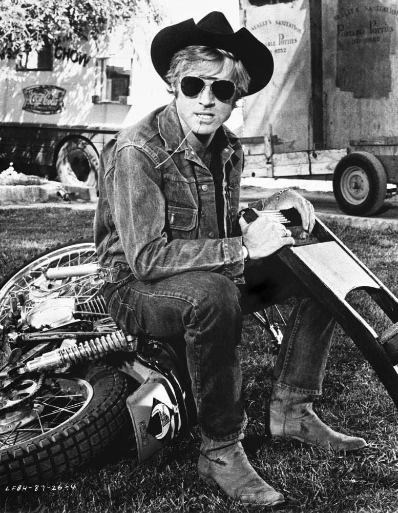 Robert Redford wearing a cowboy hat on a motorcycle photo print.
